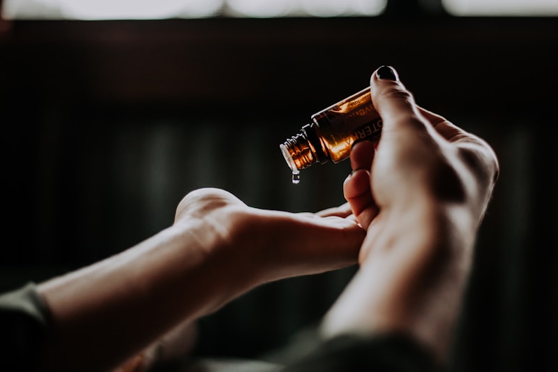Person holding amber glass bottle, healing hands